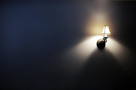 black wall sconce turned on thumbnail