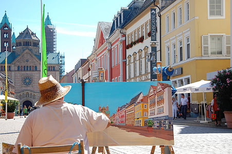 man in white shirt painting buildings thumbnail