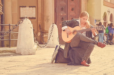 man sitting playing guitar thumbnail