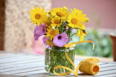 yellow and pink flowers on clear glass jar thumbnail