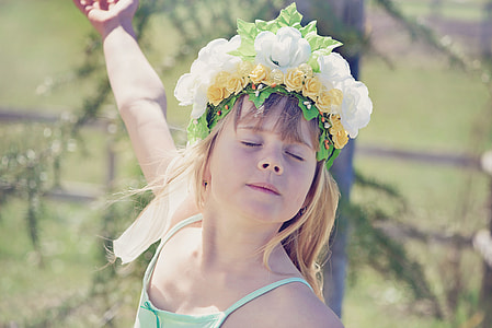 girl closing her eyes wearing white and yellow flower crown thumbnail