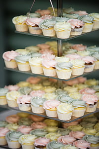 cupcakes with assorted-color icing on glass rack thumbnail