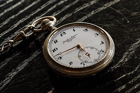 pocket watch dispaly 6:45 on black surface thumbnail