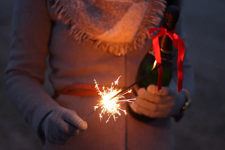 Person Holding Lighted Sparklers thumbnail