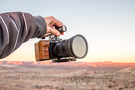 person holding DSLR camera thumbnail