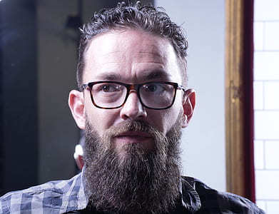man wearing brown framed eyeglasses looking to the right thumbnail