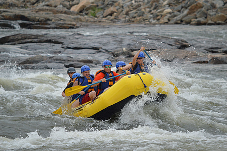 five person riding on yellow inflatable water raft thumbnail