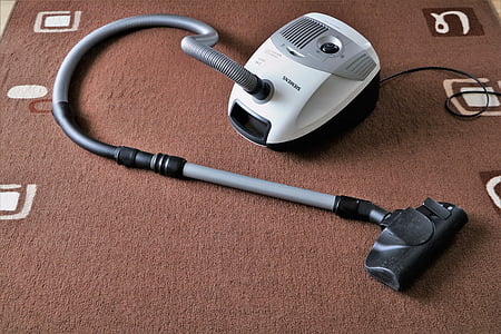 gray and white wet dry vacuum on brown area rug thumbnail