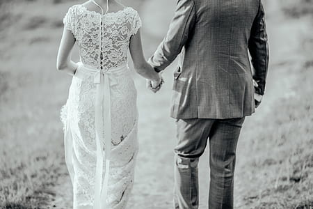 man and woman holding hands while walking thumbnail