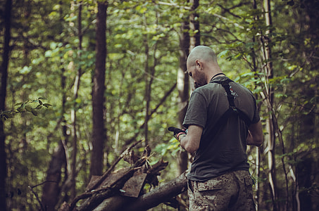 man standing in forest during daytime thumbnail