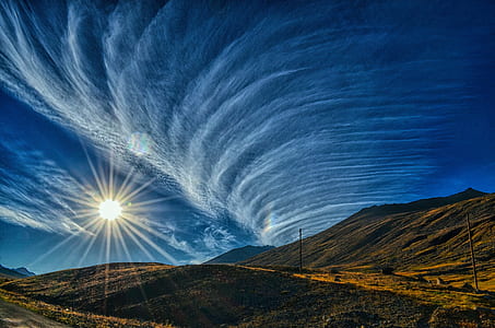 brown mountain under blue and white sky during daytime photography thumbnail