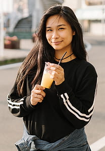 woman wearing jacket and holding disposable cup thumbnail