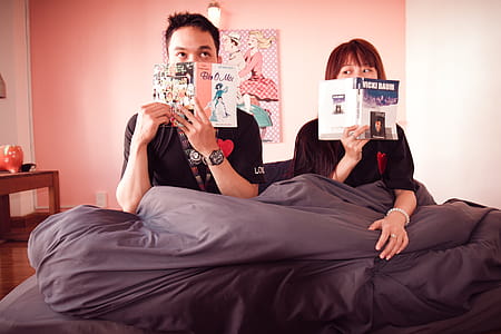 Man and Woman Holding Books thumbnail