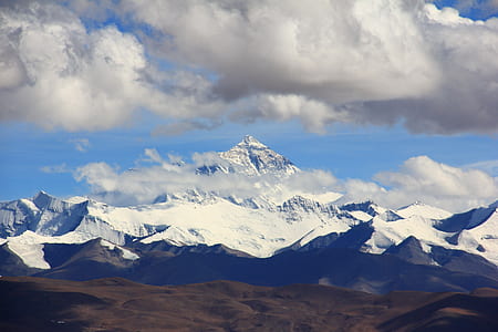 Snow Filled Mountain Under Cloudy Sky during Daytime thumbnail