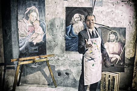 Painter With Apron Beside Portrait Paintings thumbnail