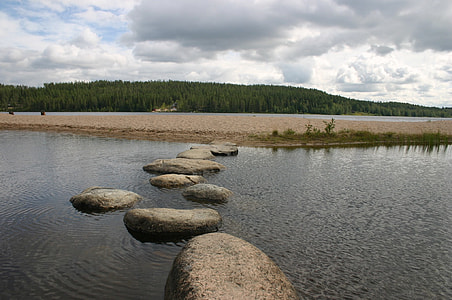 boulders on body of water thumbnail