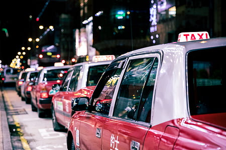 close-up photo of red taxi falling in line thumbnail