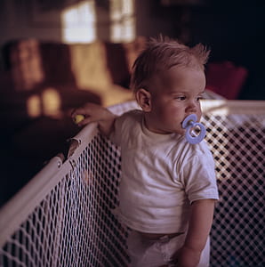 baby holding on crib thumbnail