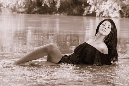 woman lying on body of water thumbnail