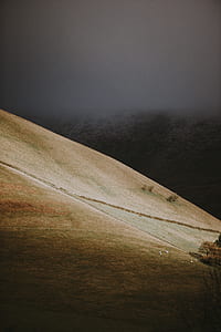brown mountain during gray cloudy sky thumbnail