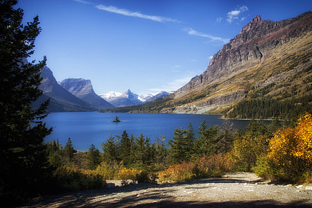blue body of water near brown mountain under blue sky thumbnail