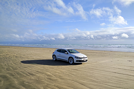 White car on sandy beach thumbnail
