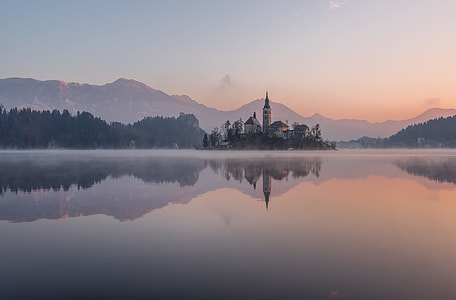 panoramic photo of white concrete buildings in middle of body of water during daytime thumbnail