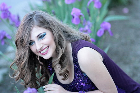 smiling woman in purple sleeveless top thumbnail