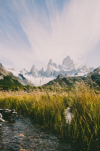 body of water near white mountain during daytime thumbnail