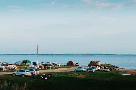 Cars Parked Near Body of Water thumbnail
