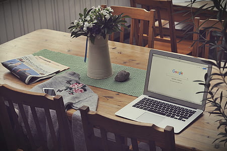 powered-on MacBook Air at top of table thumbnail