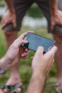 Closeup of man hands playing videogames on cell phone thumbnail