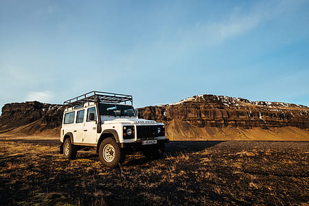white SUV parked on desert thumbnail