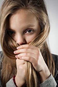 woman covering her face using her hair thumbnail