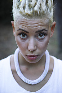woman wearing silver-colored necklace and white scoop-neck top thumbnail