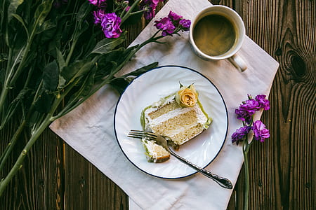 round plate of sliced cake with fork beside thumbnail