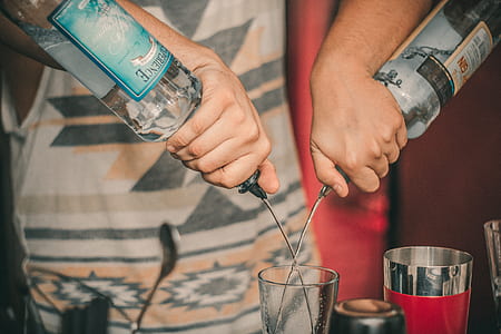 Person Holding Two Soda Bottles With Drinking Glass Below thumbnail