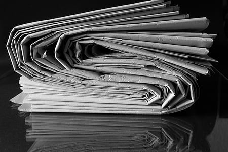 gray paper on top black surface closeup photo thumbnail