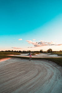 person standing on golf course thumbnail