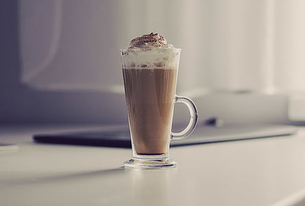 clear glass mug with brown liquid on table thumbnail