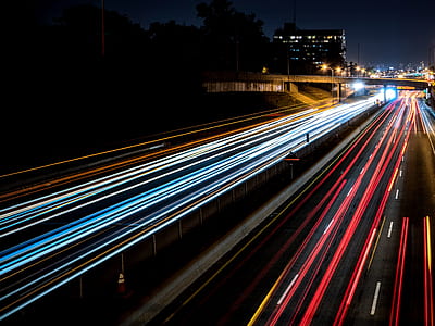 photography of black empty road near buildings at nighttime thumbnail