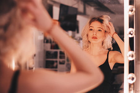 woman looking to mirror thumbnail