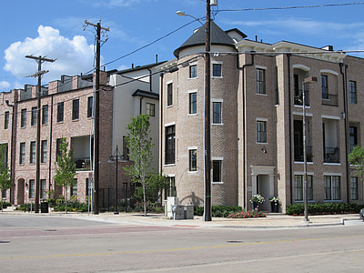 brown concrete buildings beside gray concrete road during daytime thumbnail