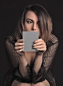closeup photo of woman holding mirror thumbnail