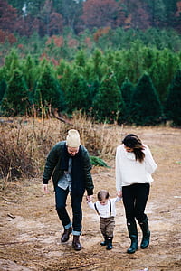 woman, man, and toddler walking together thumbnail