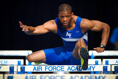 man wearing blue Nike suit jumping on wooden ramp thumbnail