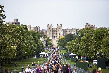 photo of people walking along pathway near castle thumbnail