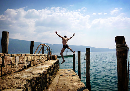 man jumps on ocean thumbnail