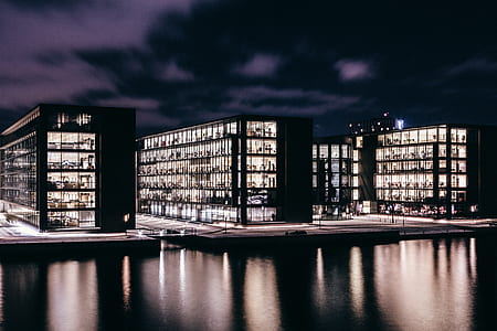 lighted buildings near body of water thumbnail