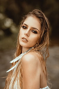 woman with white sleeveless tops and blonde hair at daytime thumbnail